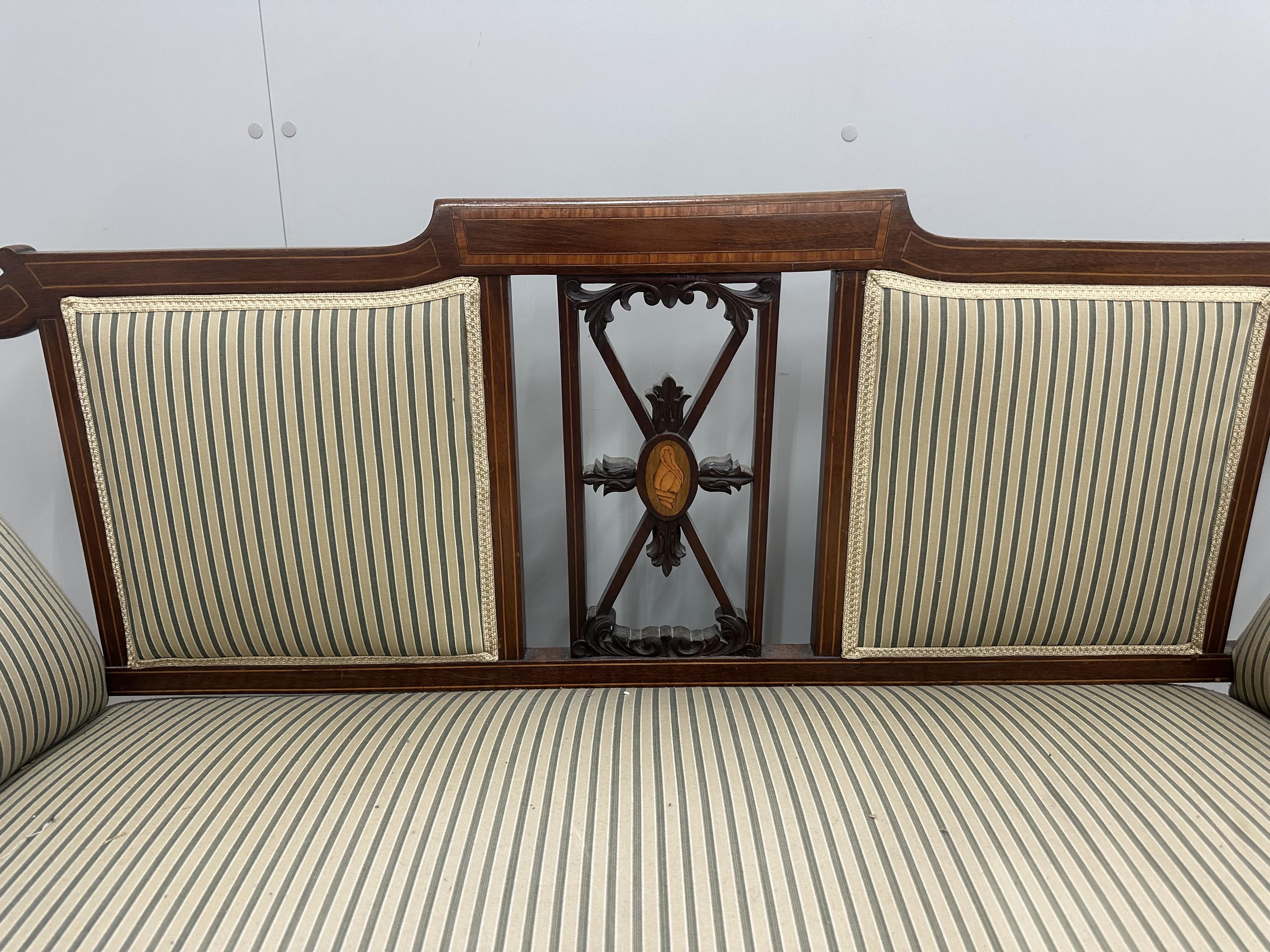 An Edwardian inlaid mahogany settee, width 150cm, depth 60cm, height 84cm. Condition - fair